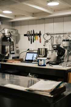 Modern commercial kitchen workspace with industrial mixers and stainless steel equipment